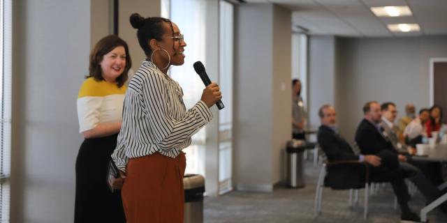 An attendee asks a question at United Way's Policy With a Splash of Coffee forum on higher education and workforce readiness.