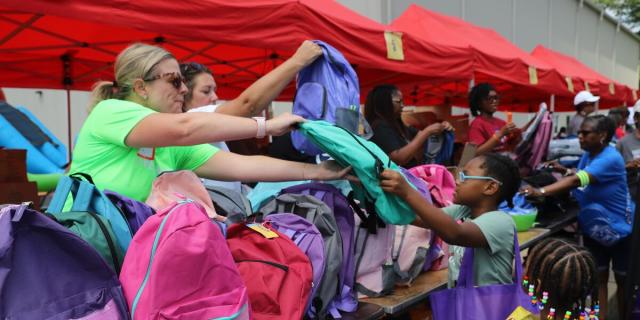 United Way staff distribute backpacks and supplies to the community.